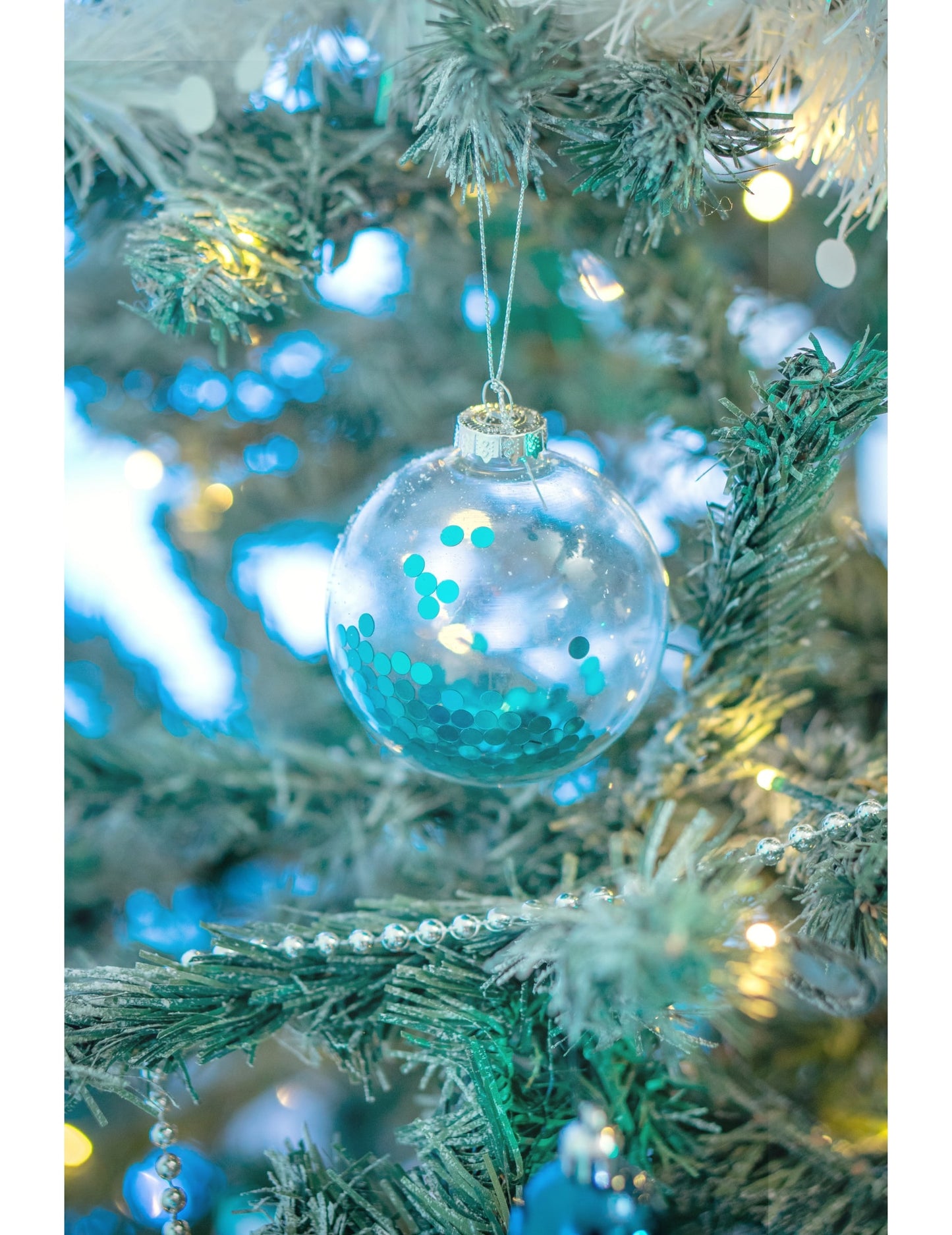 Mise en situation dans le sapin des boules en verre de Noël pour sapin transparentes avec paillettes bleues