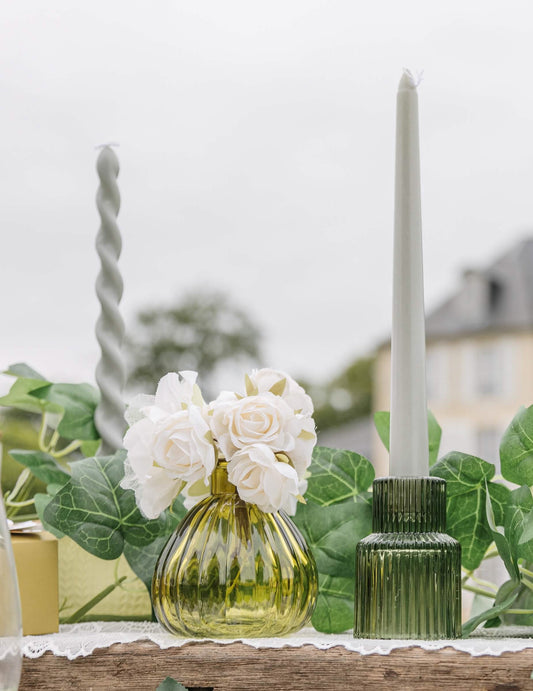 Mise en scène avec roses blanches du vase en verre strié pistache