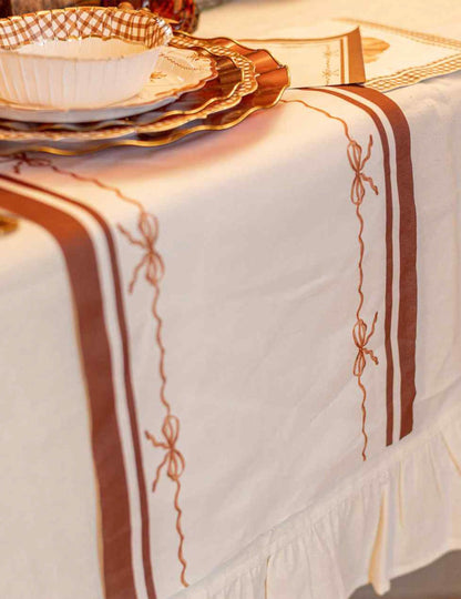 Chemin de table Jolis Nuds en tissu crème auburn et terre brûlée 28 cm x 3 m