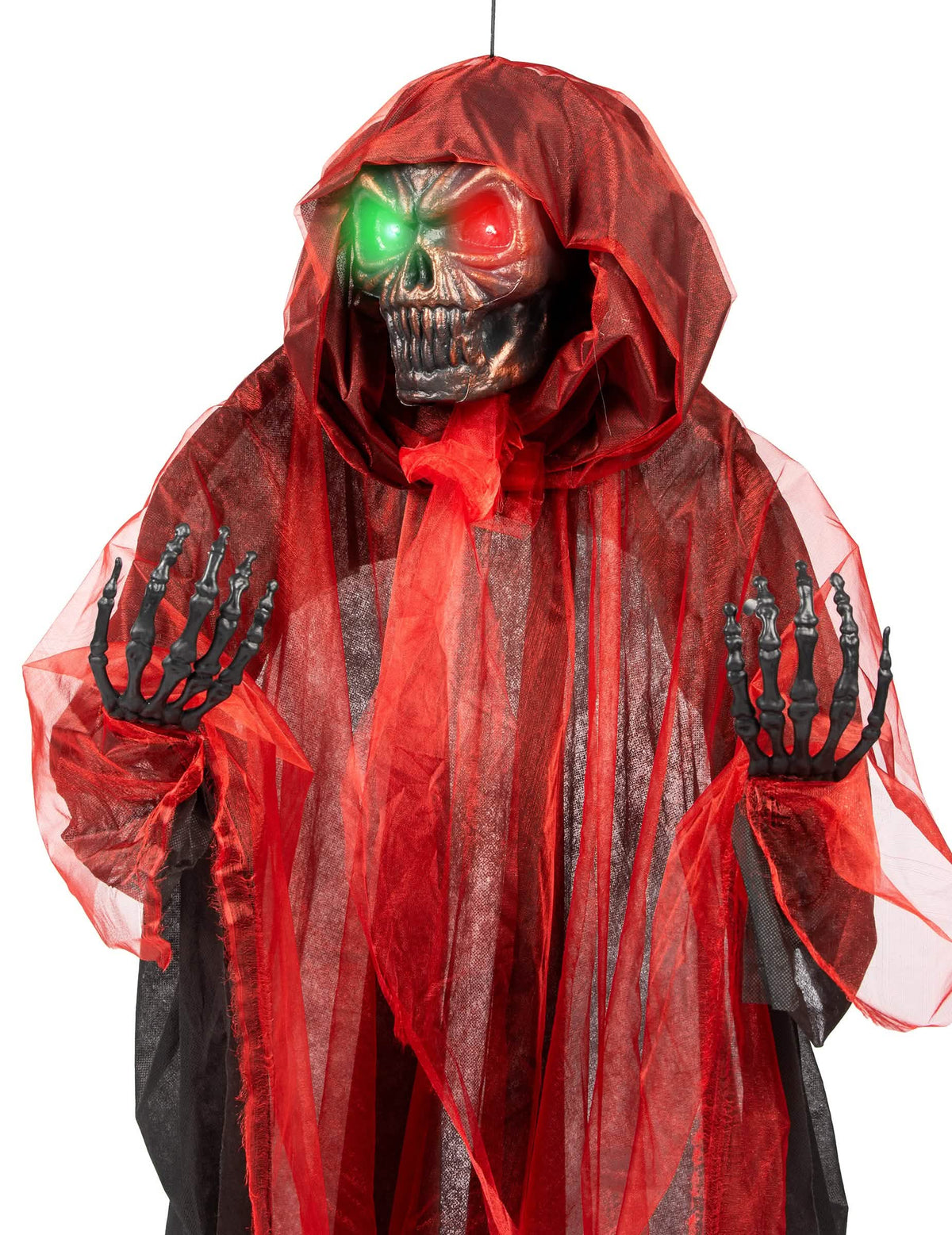 Gros plan sur les yeux lumineux et les mains de la décoration suspendue Démon pour Halloween