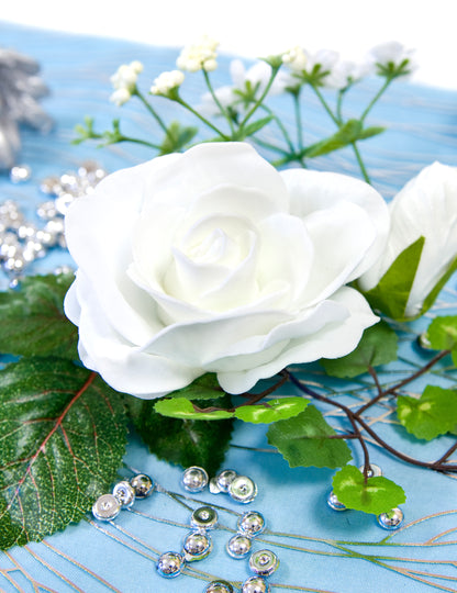 Gros plan sur la rose de la petite composition fleurs artificielles mariage pour centre de table blanches