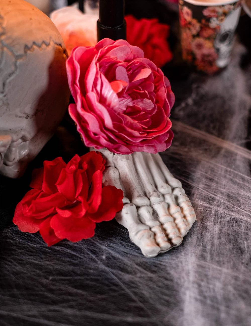 Detail van een skeletvoet versierd met bloemen van de bottenzak 12 stuks halloween