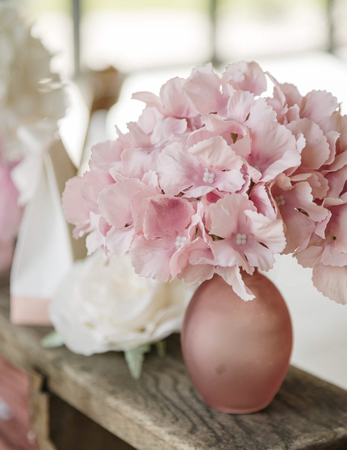 Gros plan sur les fleurs du vase en verre décoration pour table rose finition givrée